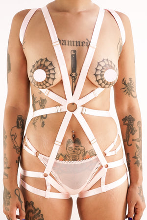 A woman in a pink Charlie harness.