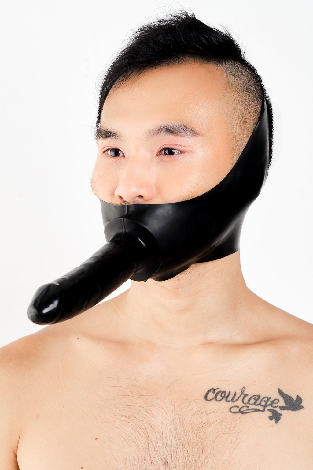 A man wearing a latex dildo mask.