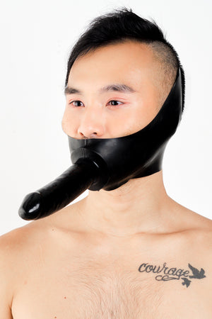 A man wearing a latex dildo mask.