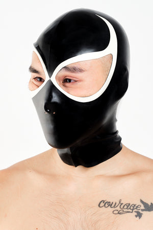 A man wearing a black and white lucha libre latex wrestling hood.