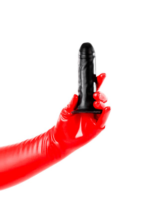 Red latex gloves holding a medium solid butt plug.