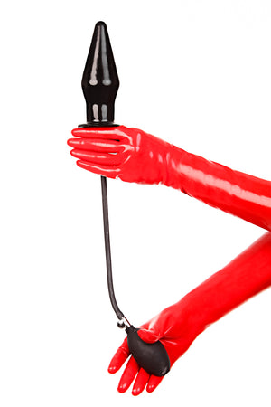 Red latex gloves holding an extra large inflatable butt plug.