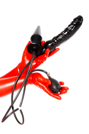 Red latex gloves holding a joint butt plug and dildo combo.