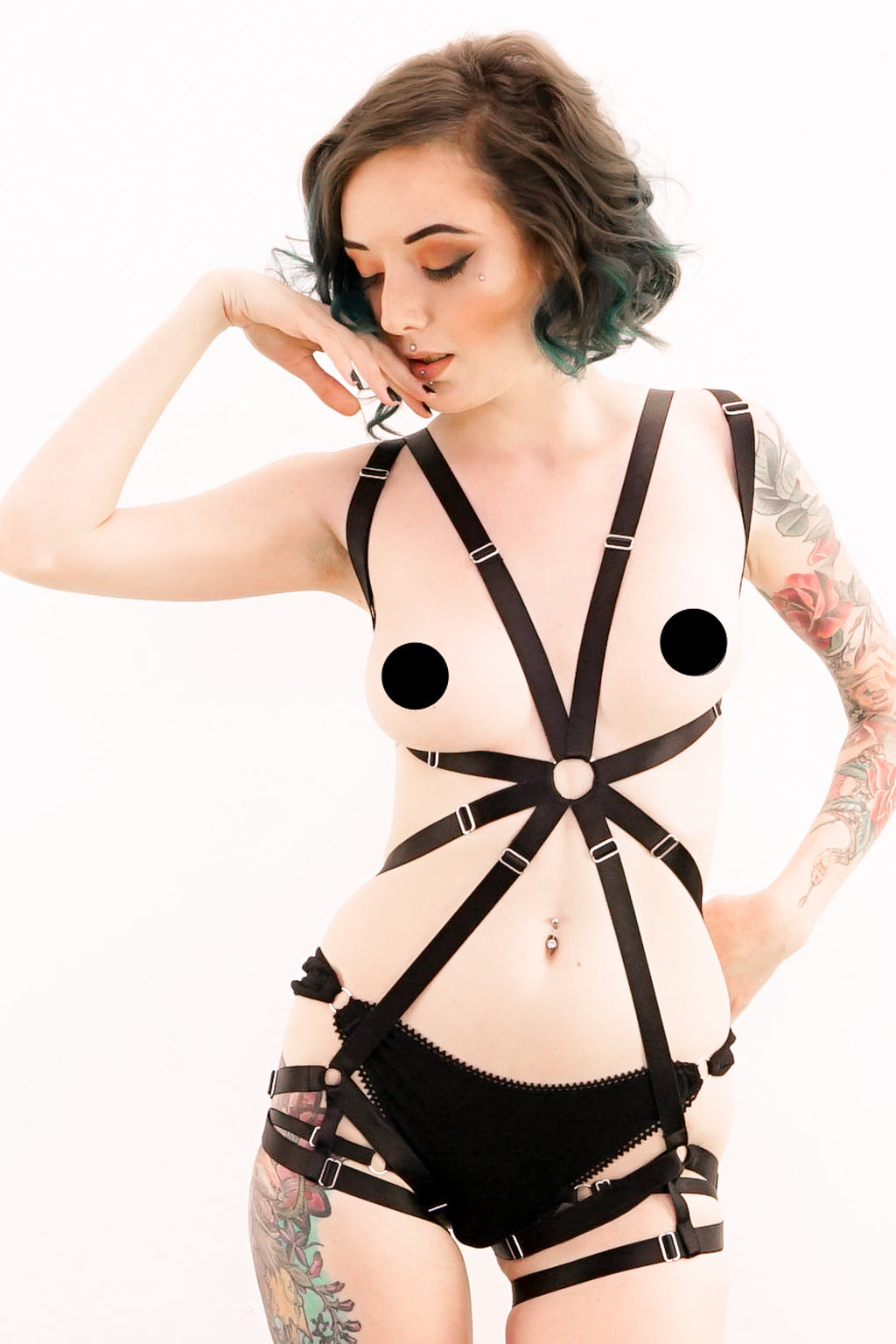 A woman wearing a black one piece harness.