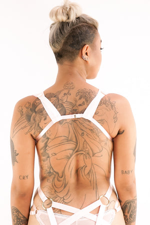 The back of a woman in a Charlie harness.