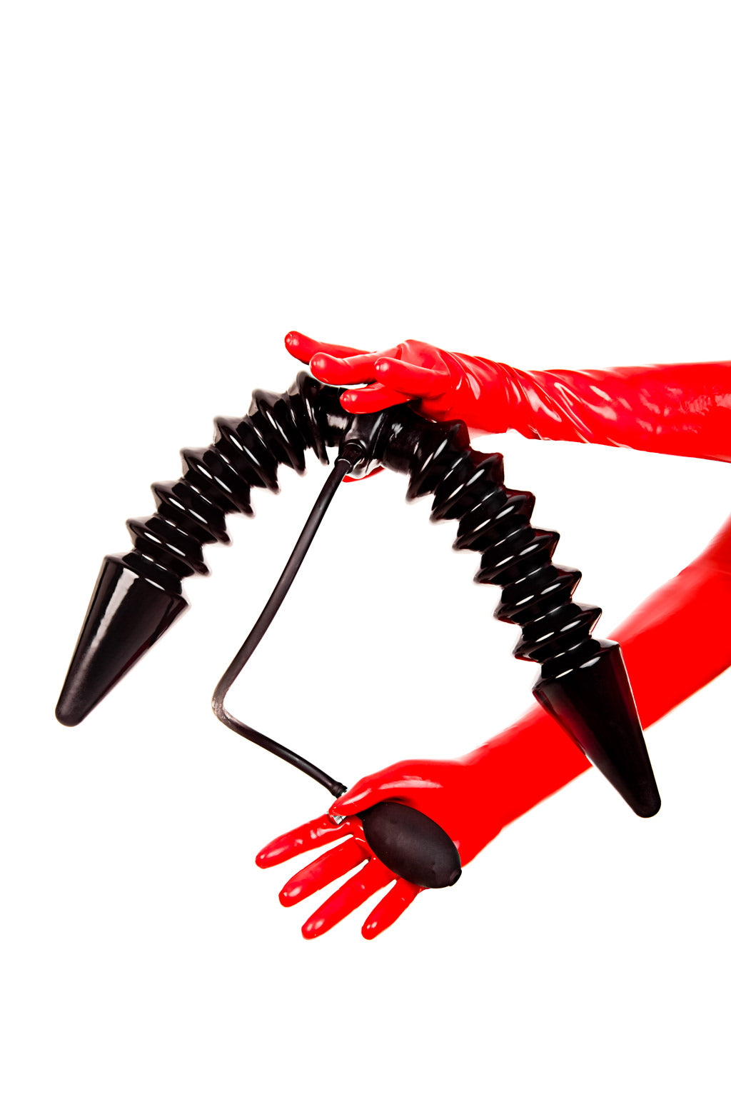 Red latex gloves holding a dual inflatable butt plug with a single pump.