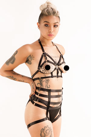 A woman wearing a black Jesse harness.