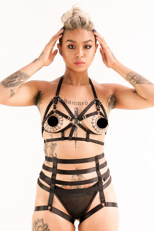 A woman wearing a black two piece harness.