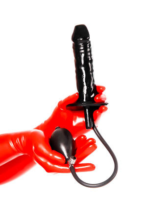 Red latex gloves holding a large inflatable enema plug.