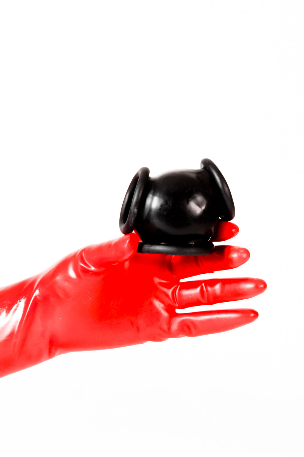 Red latex gloves holding a latex ball bag.