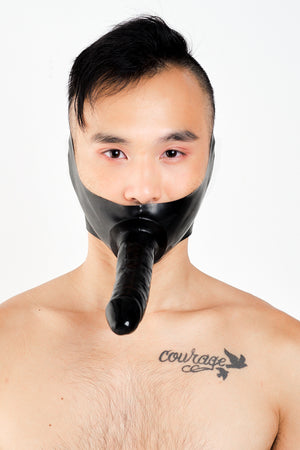 A man wearing a black latex dildo mask.