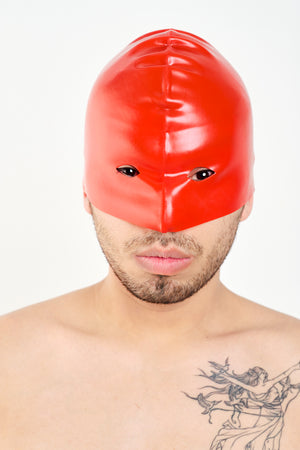 A man wearing a red latex executioners mask.