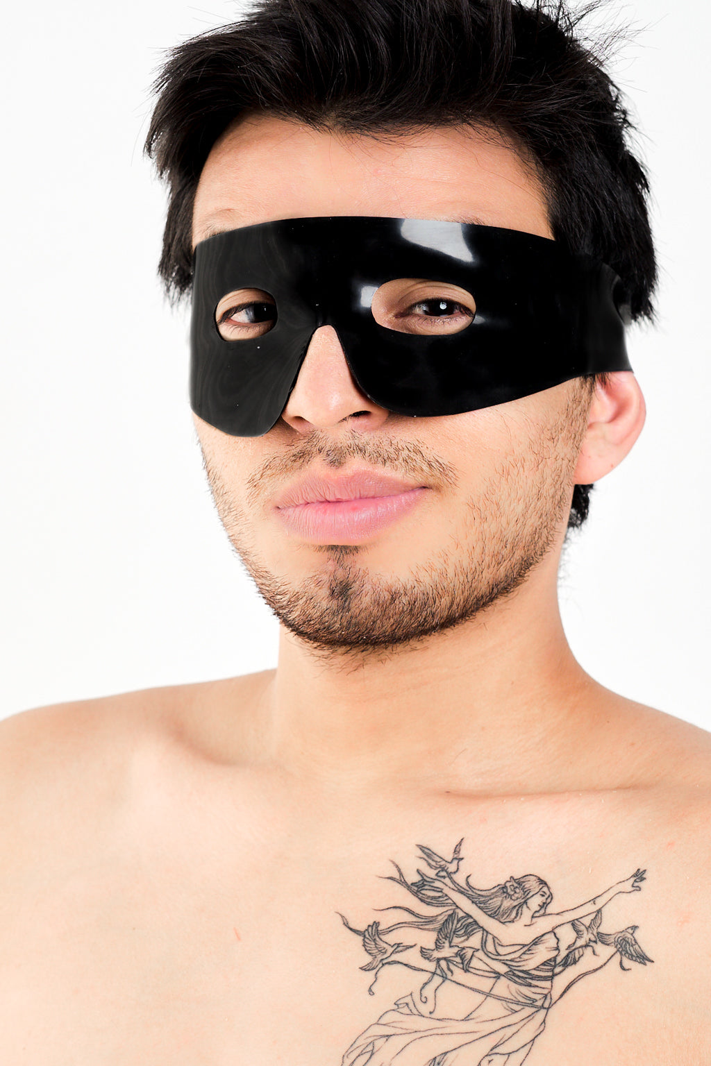 A man wearing a black latex Zorro mask.