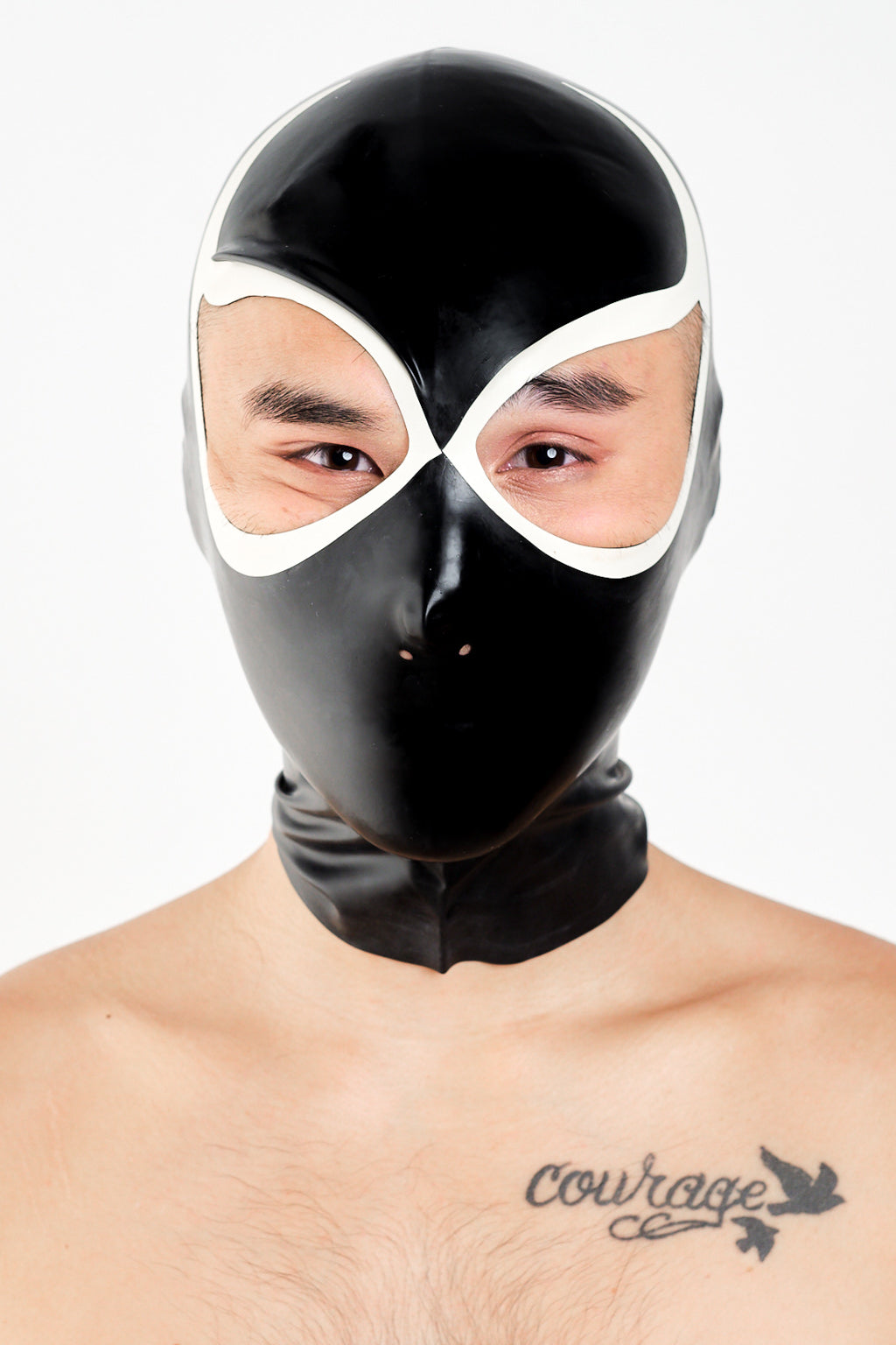 A man wearing a black and white lucha libre latex wrestling hood.
