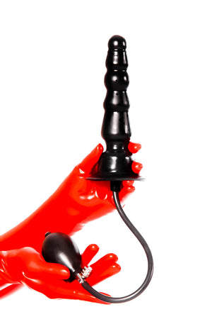 Red latex gloves holding an inflatable ribbed butt plug.