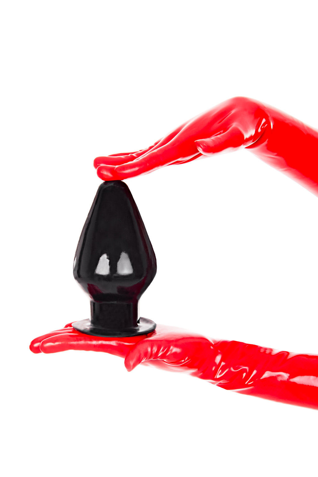 Red latex gloves holding a solid large wide butt plug.