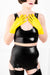 A woman wearing a latex outfit with yellow latex wrist gloves.